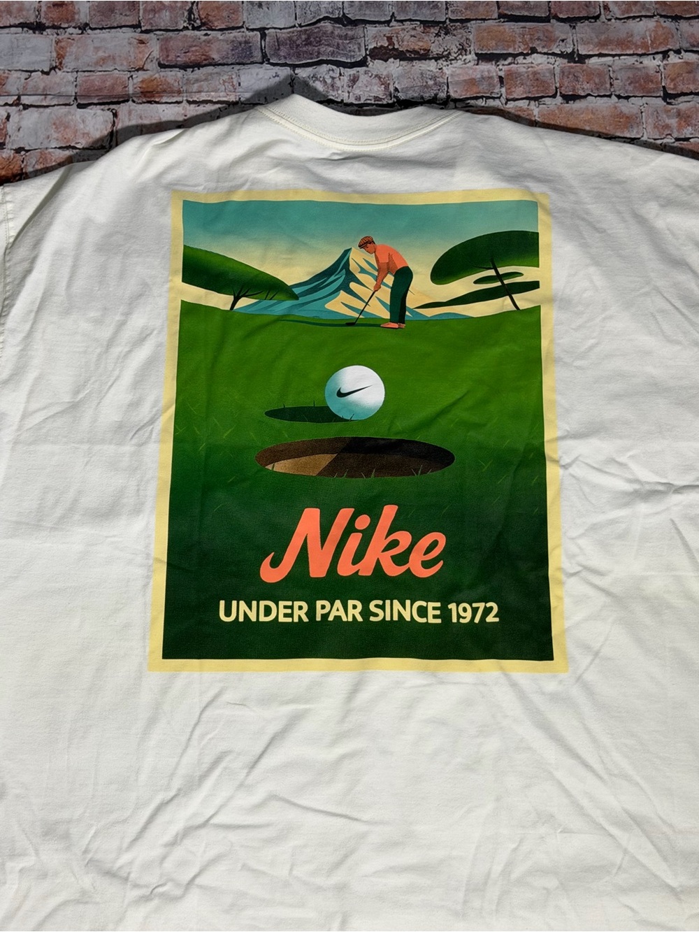 Nike White Short-Sleeve Tee with Green Golf Graphic and Coral Logo
